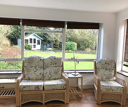 Interior photo of Church Cottage showing the dining room with French doors to the rear garden & patio